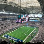 A packed AT&T Stadium in Arlington, Texas, showcasing a thrilling football game with enthusiastic fans.